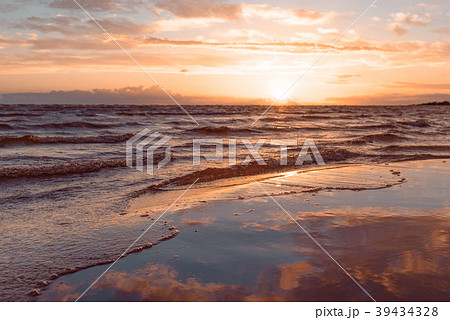 Evening sky reflected in water on sand as in a 39434328