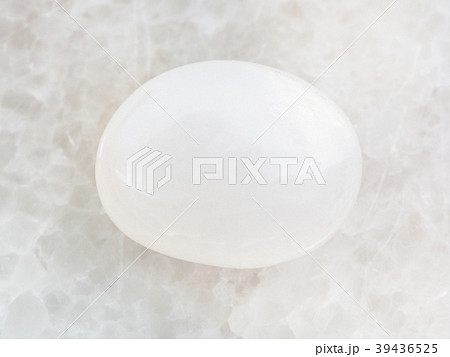 tumbled milky quartz gemstone on white marble tumbled milky quartz gemstone on white marble 39436525