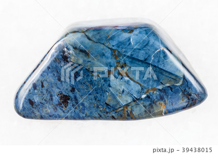 polished rhodusite gemstone on white marble 39438015