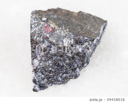 rough antimonite stone on white marble 39438016