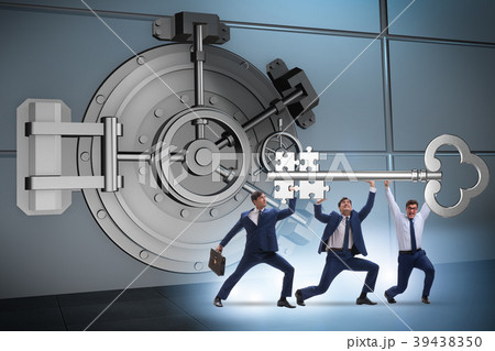 Businessman with key near bank vault door Businessman with key near bank vault door 39438350