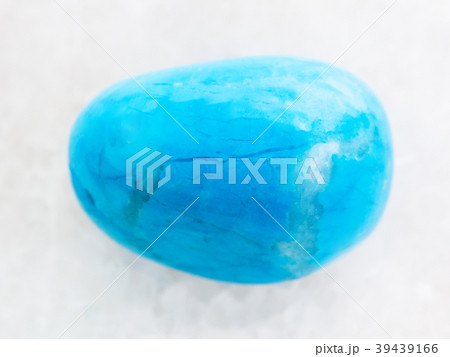 tumbled Turquenite (blue howlite) stone on white 39439166