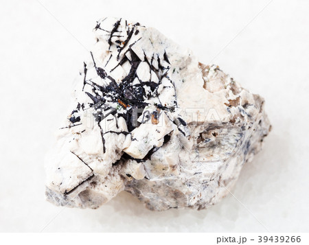 Ilmenite black crystals on stone on white 39439266