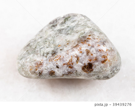 chondrodite in tumbled calcite stone on white chondrodite in tumbled calcite stone on white 39439276