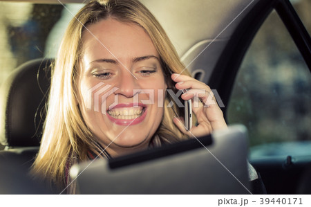 Young businesswoman using tablet computer in taxi Young businesswoman using tablet computer in taxi 39440171