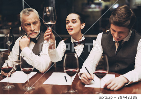 Beautiful female sommelier holding glass of wine Beautiful female sommelier holding glass of wine 39443388