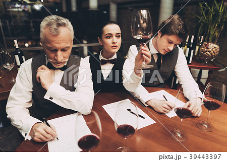 Beautiful female sommelier holding glass of wine 39443397