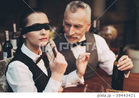 Experienced sommelier with bandage on eyes 39443421