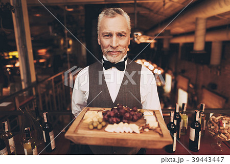 Sommelier is holding snacks for red wine Sommelier is holding snacks for red wine 39443447