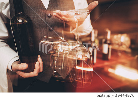 Sommelier holding with bottle of wine  39444976