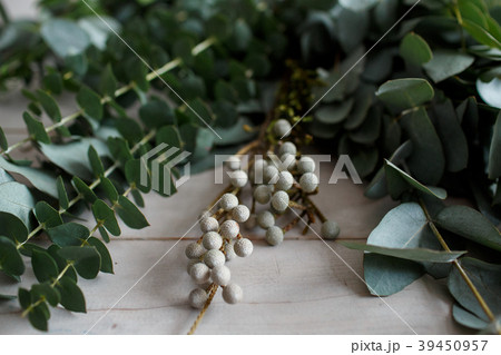 Eucalyptus leaves on a wooden white table Eucalyptus leaves on a wooden white table 39450957