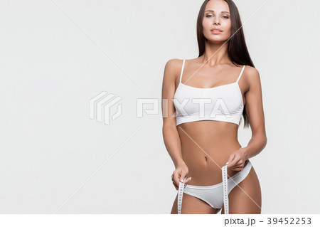 Young beautiful girl measures your body parts of 39452253
