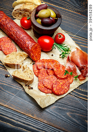 Dried organic salami sausage on wooden background Dried organic salami sausage on wooden background 39458289