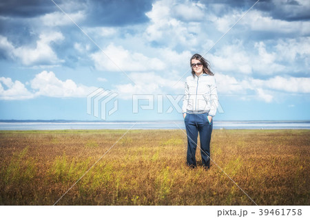 Young woman smiling in the midst of a orange lawn 39461758