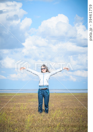 Young woman smiling in the midst of a orange lawn 39461759