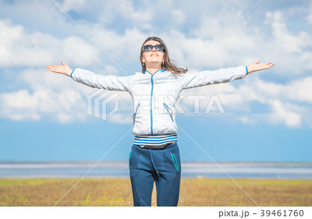 Young woman smiling in the midst of a orange lawn 39461760
