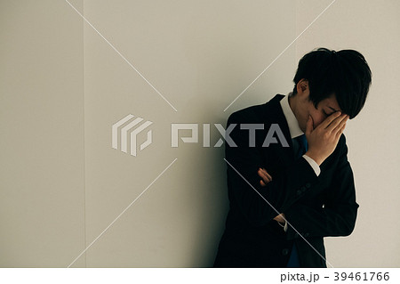 顔を覆う若いビジネスマン 日本人男性の写真素材