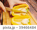 Female person slicing yellow bell pepper 39466484