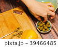 Woman cutting green olives for cooking 39466485