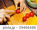 Female person slicing cherry tomatoes 39466486