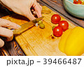 Young female person slicing green olives for salad 39466487