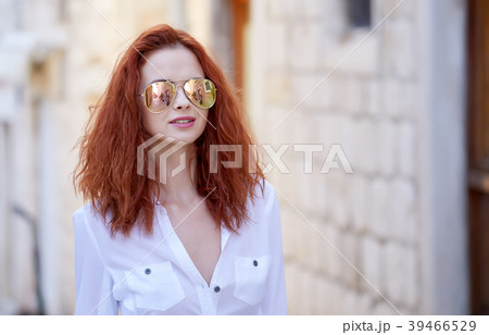 Portrait of happy smiling woman standing on the square on sunny 39466529