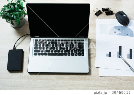 Open laptop on office wooden desk table. Open laptop on office wooden desk table. 39469313