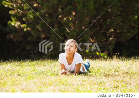 Teenage girl lying on the grass Teenage girl lying on the grass 39470157