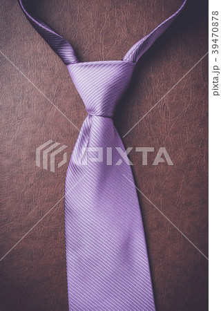 Purple necktie on elegant leather background Purple necktie on elegant leather background 39470878