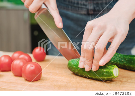 close-up of female hands cut into fresh cut 39472108