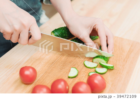 close-up of female hands cut into fresh cut 39472109