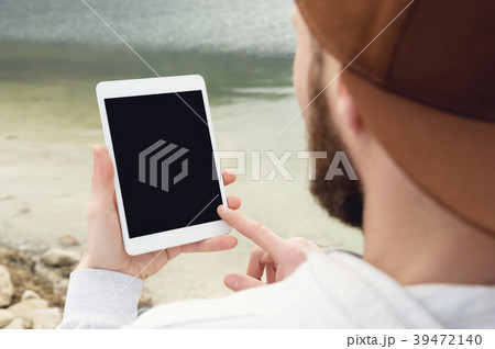 Close-up of a hipster in a brown cap in the open 39472140