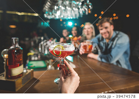 Woman arm holding glasses of alcohol beverage Woman arm holding glasses of alcohol beverage 39474578