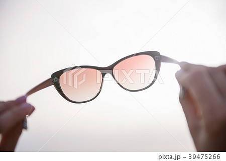 Lady is carrying her glasses opposite sunshine 39475266