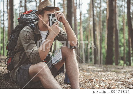 Optimistic traveler is making photo of nature Optimistic traveler is making photo of nature 39475314