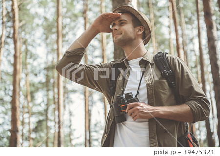 Young tourist is walking along pinewood 39475321