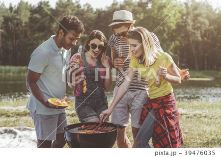 Rejoicing young company roasting beer snacks in Rejoicing young company roasting beer snacks in 39476035