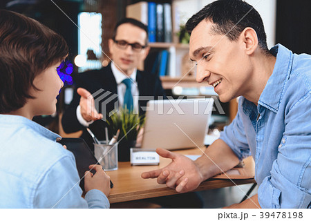 Realtor sitting at desk in office. Realtor sitting at desk in office. 39478198