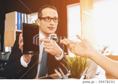 Realtor sitting at desk in office. Realtor sitting at desk in office. 39478201