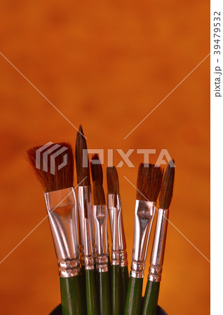 A set of paint brushes on a brown background 39479532