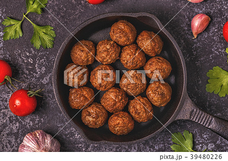 Roasted meatballs with tomatoes, garlic parsley. Roasted meatballs with tomatoes, garlic parsley. 39480226