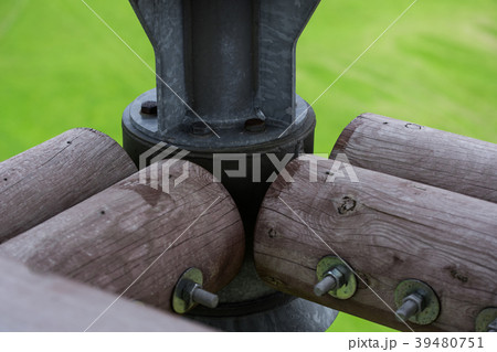 Wooden beams connected by metal screw and nut 39480751