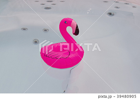 One floating pink flamingo in bathtub 39480905