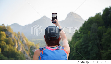 Picture from back of female tourist photographing 39485836