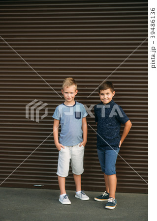 Two children are playing in the park. Two 39486136