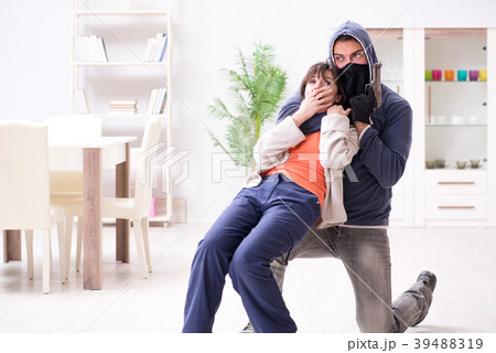 Armed man assaulting young woman at home 39488319