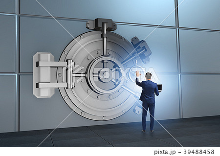 Businessman in front of banking vault door Businessman in front of banking vault door 39488458