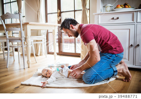 Father changing a baby girl at home. 39488771