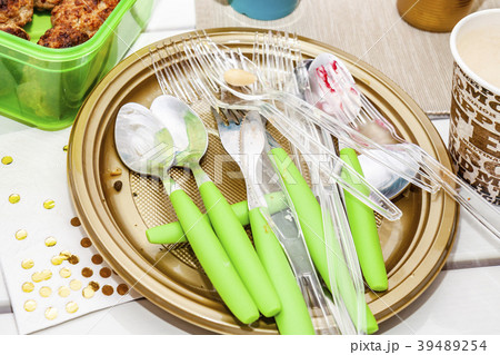 Used plate with salad and cutlery 39489254