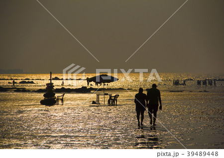 Silhouette with couple walking on Alibag beach 39489448